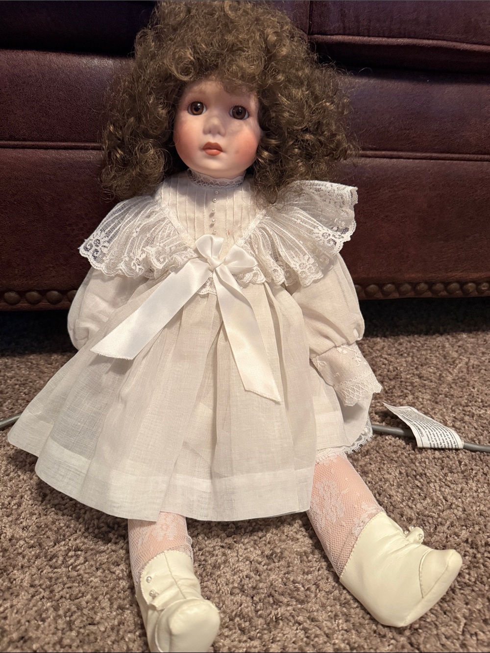 Vintage Porcelain doll in a Victorian white gown.
